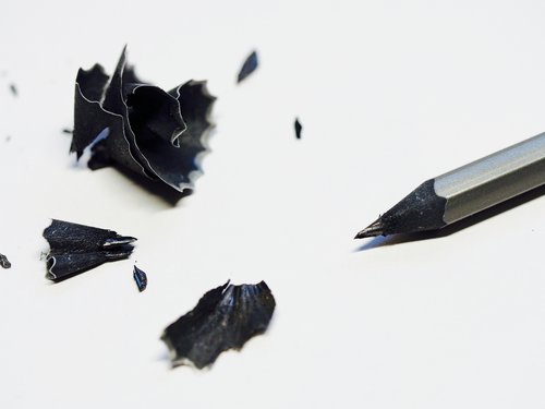 Black pencil with a pile of pencil shavings