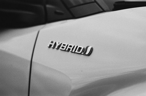 Silver "Hybrid" emblem on a white car