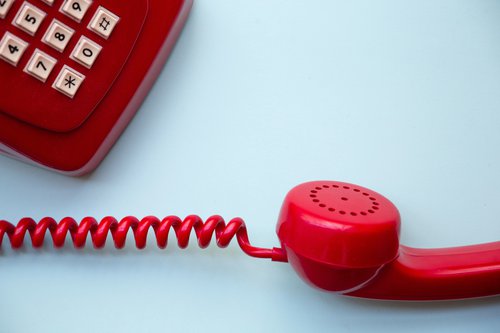 Dial pad and handset of a red corded telephone