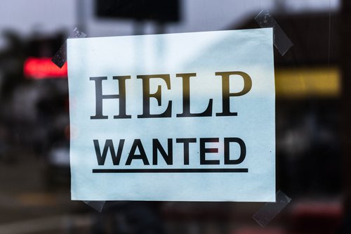 "Help Wanted" sign in a window